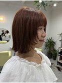 オレンジカラーの顔まわりレイヤーボブ