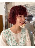 red color × curly bob