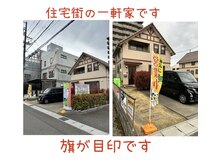 カイロプラクティックサロン 伝々夢志の雰囲気（静かな住宅街の中の一軒家目の前が駐車場。旗がたっています）
